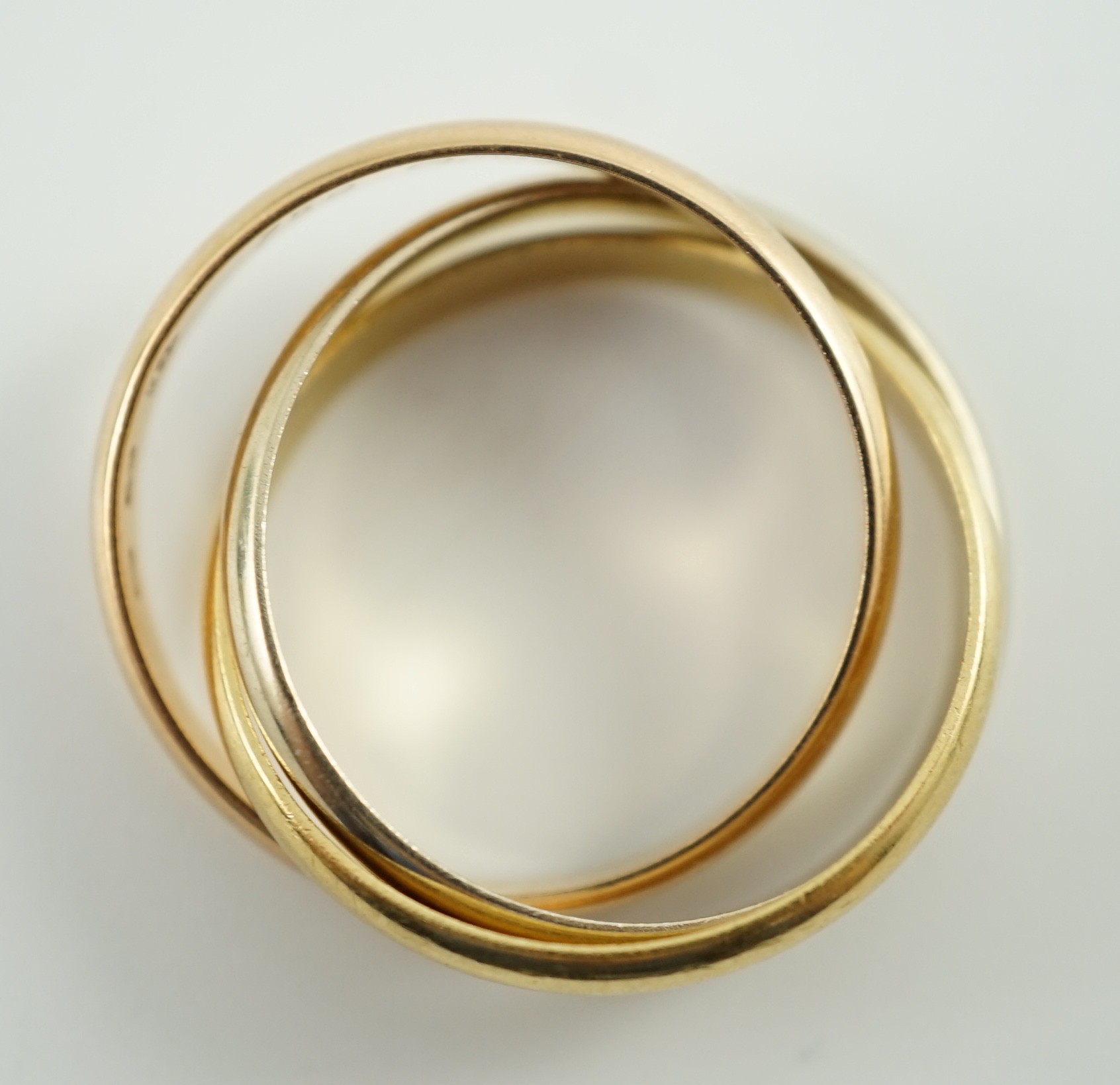 A modern 18ct three colour Cartier 'Russian' triple wedding band